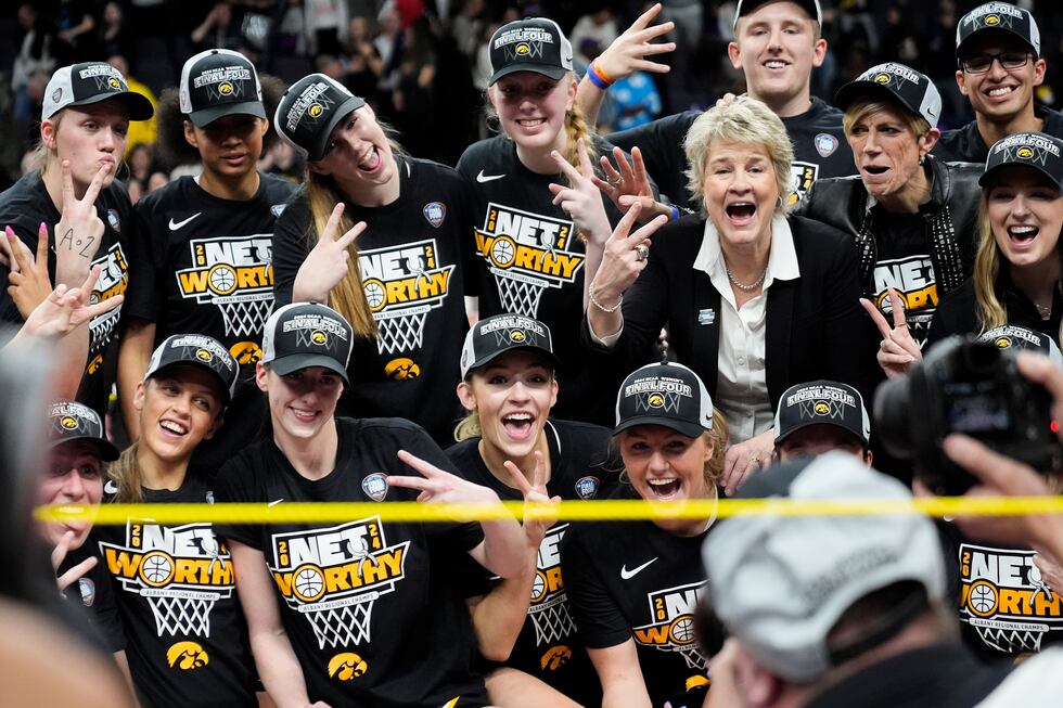 Iowa head coach Lisa Bluder and players pose for a team photo after defeating LSU in an Elite...