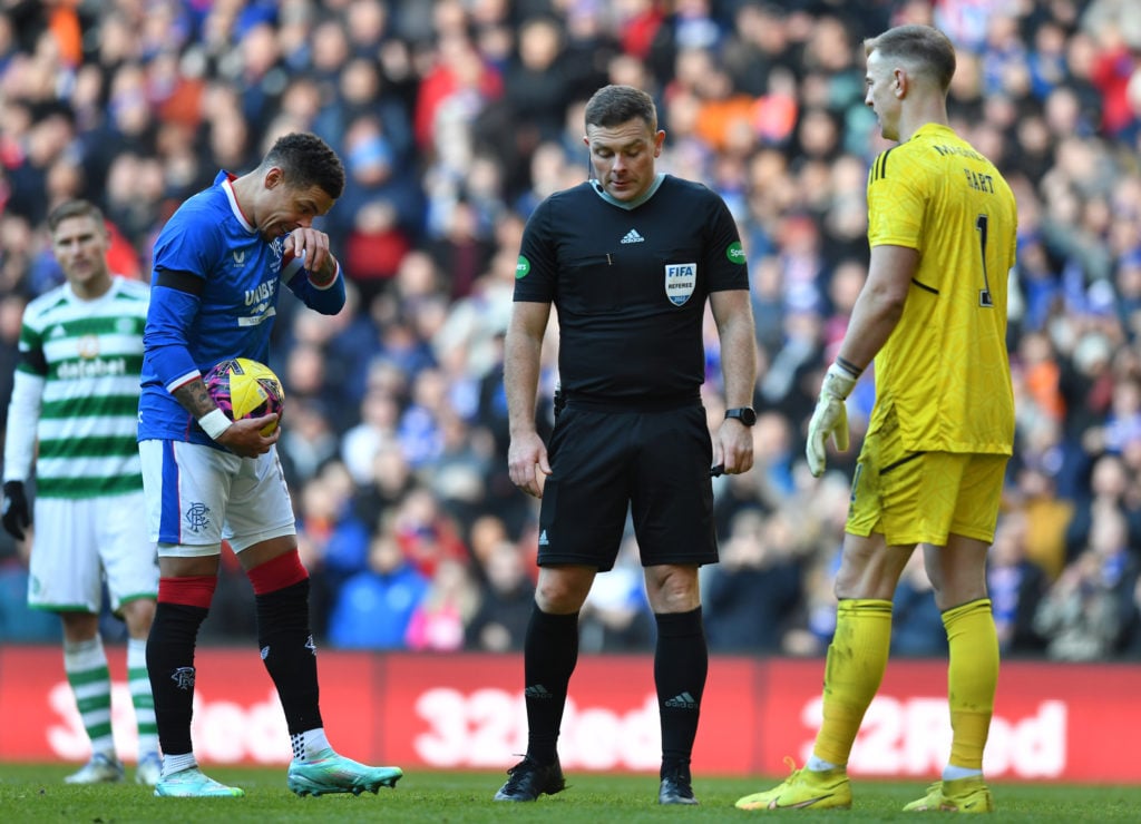 James Tavernier of Rangers (L), stands at the penalty spot with Joe Hart of Celtic and match referee John Beaton during the Cinch Scottish Premiers...