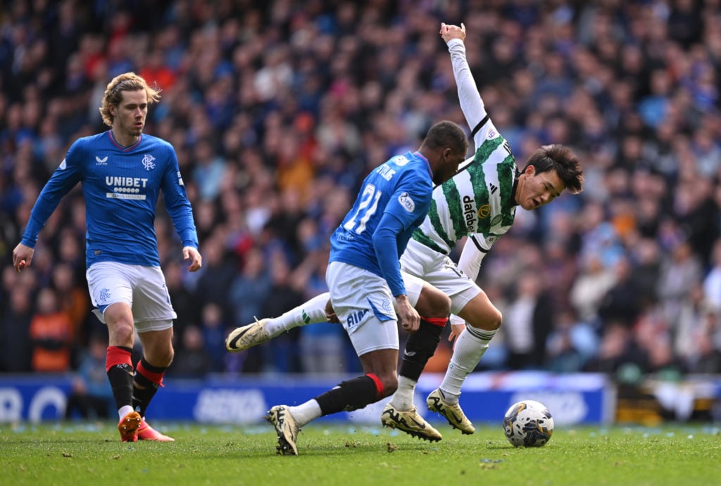 Celtic player Hyunjun Yang is challenged by Dujon Sterling of Rangers during the Cinch Scottish Premiership match between Rangers FC and Celtic FC ...