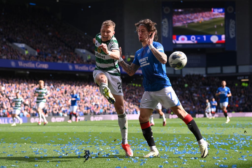 Celtic player Alistair Johnston (l) is challenged by Fabio Silva of Rangers as tickertape litters the field during the Cinch Scottish Premiership m...